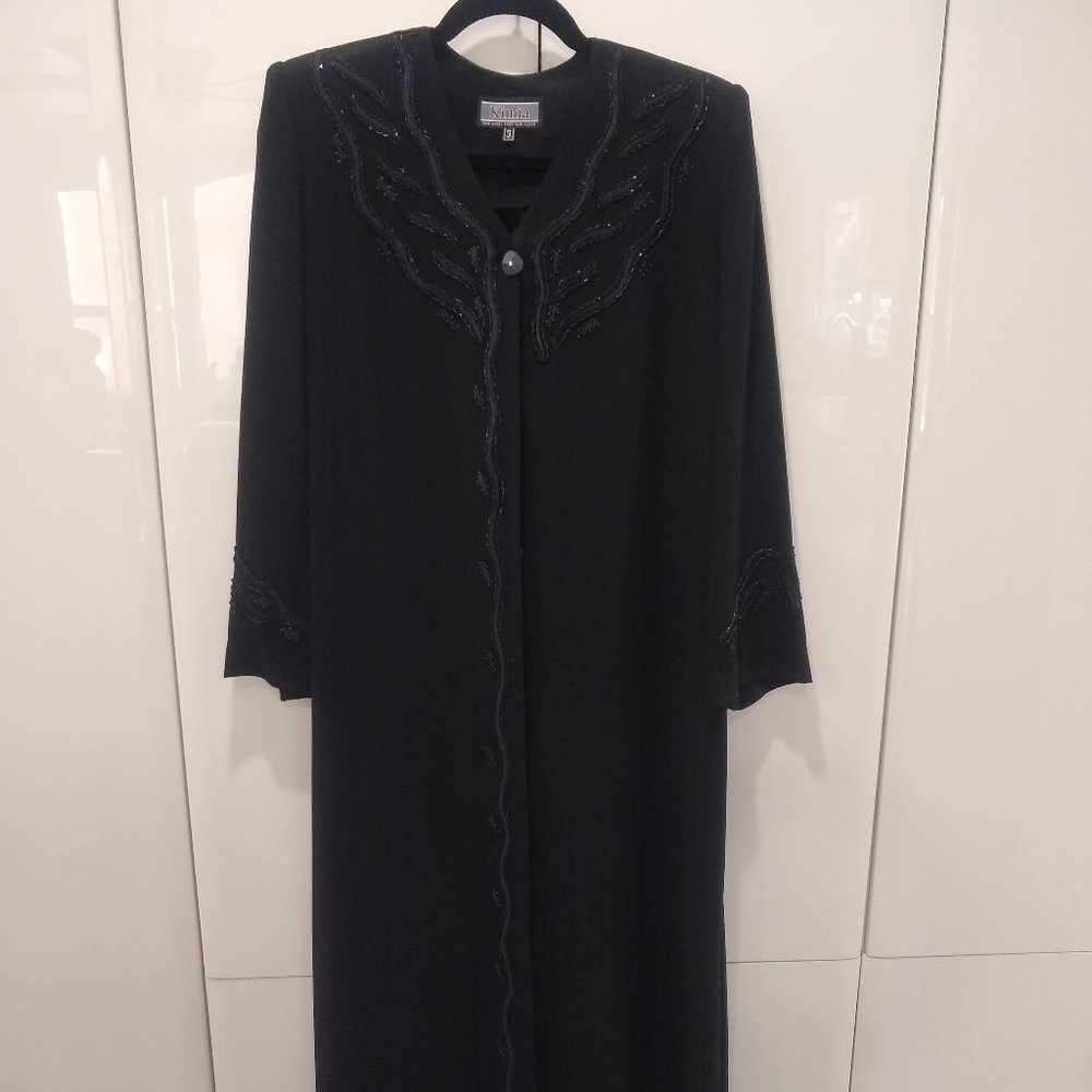 Long sheer black blouse dress with button detail.